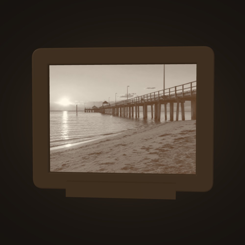 A beach jetty at sunset, lit